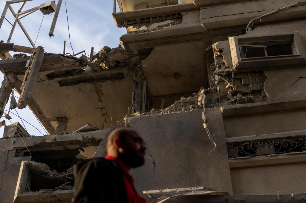 Attack on central Israel injures 11 as Iran’s leader promises a punishing response
