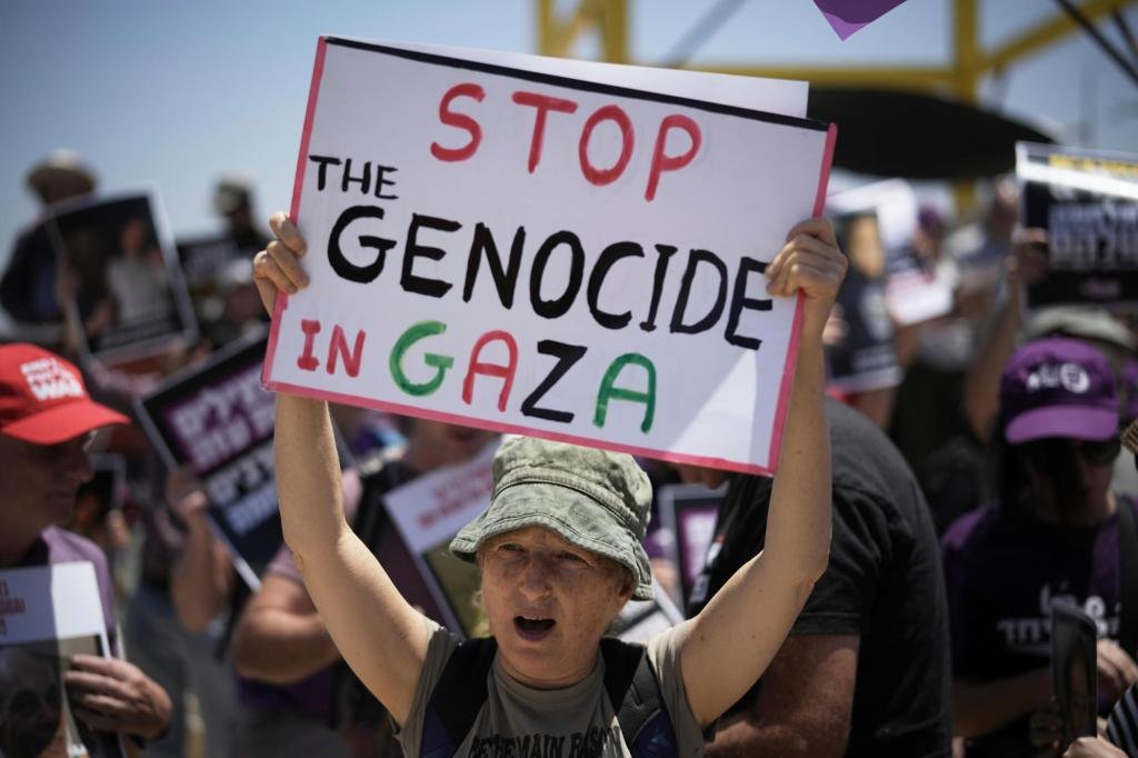 At least 60 people killed by Israeli strikes in Gaza as Israel lets minimal aid in